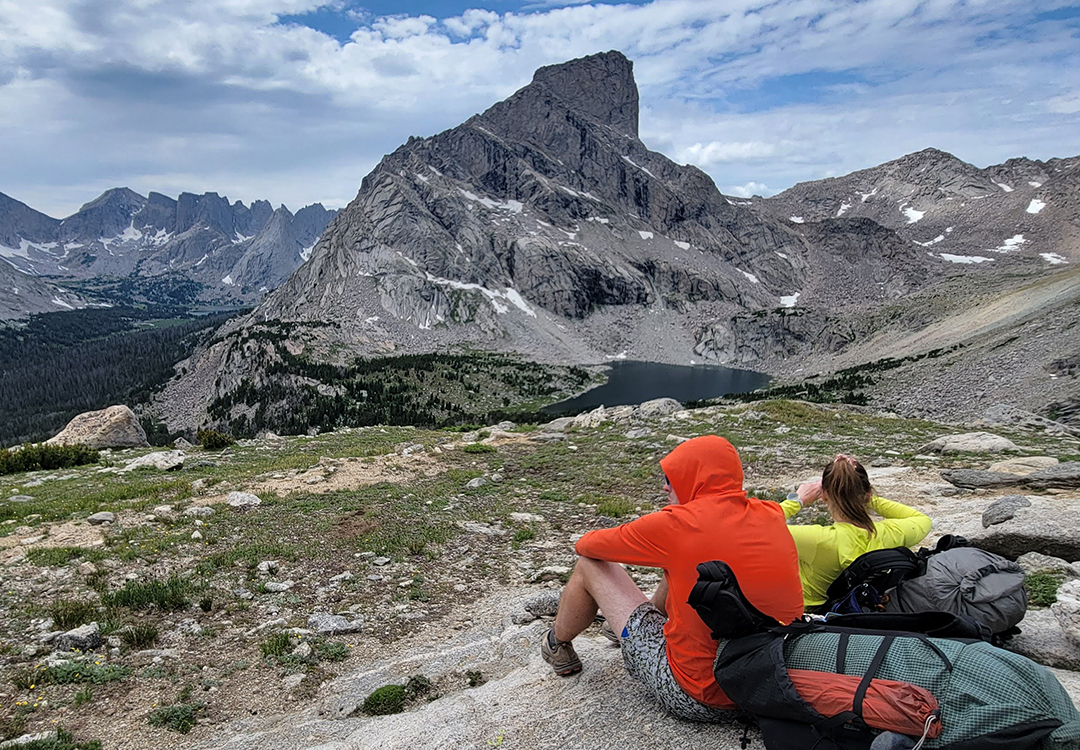 post16 Backpacker reaches for his bear spray from the ULA Deploy Bear Canister Holder on his shoulder strap.