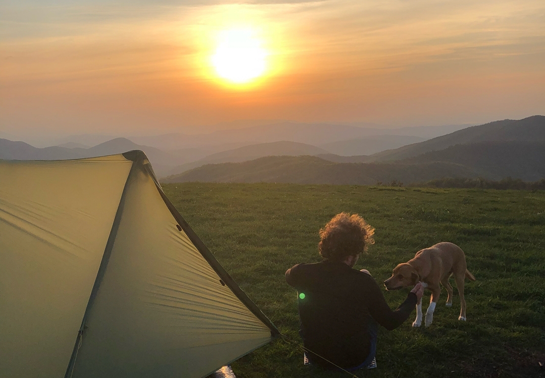 Backpacker sitting on a BearVault. The BearVault also makes an excellent chair. 