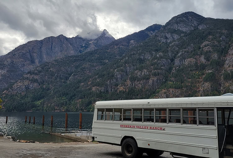 Backpacker sitting on a BearVault. The BearVault also makes an excellent chair. 