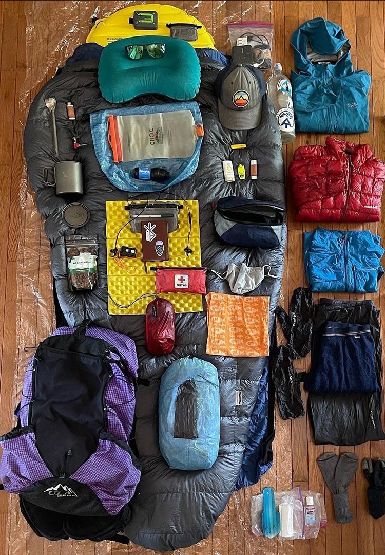 Backpacker puts a Bear Vault Bear Canister into a ULA CDT Backpack