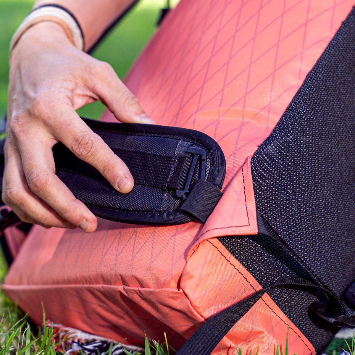 Hiker tucks phone into elastic topped mesh hind pocket