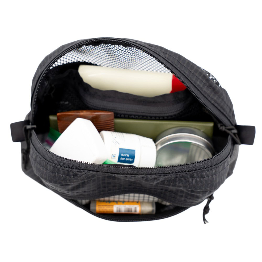 Interior of ULA toiletries Kit. Inside is filled with toiletries.