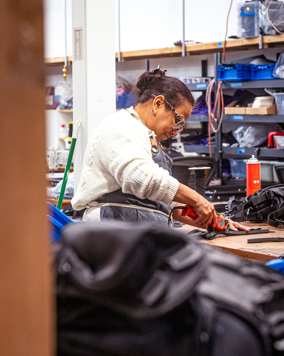 Backpacker puts a Bear Vault Bear Canister into a ULA CDT Backpack