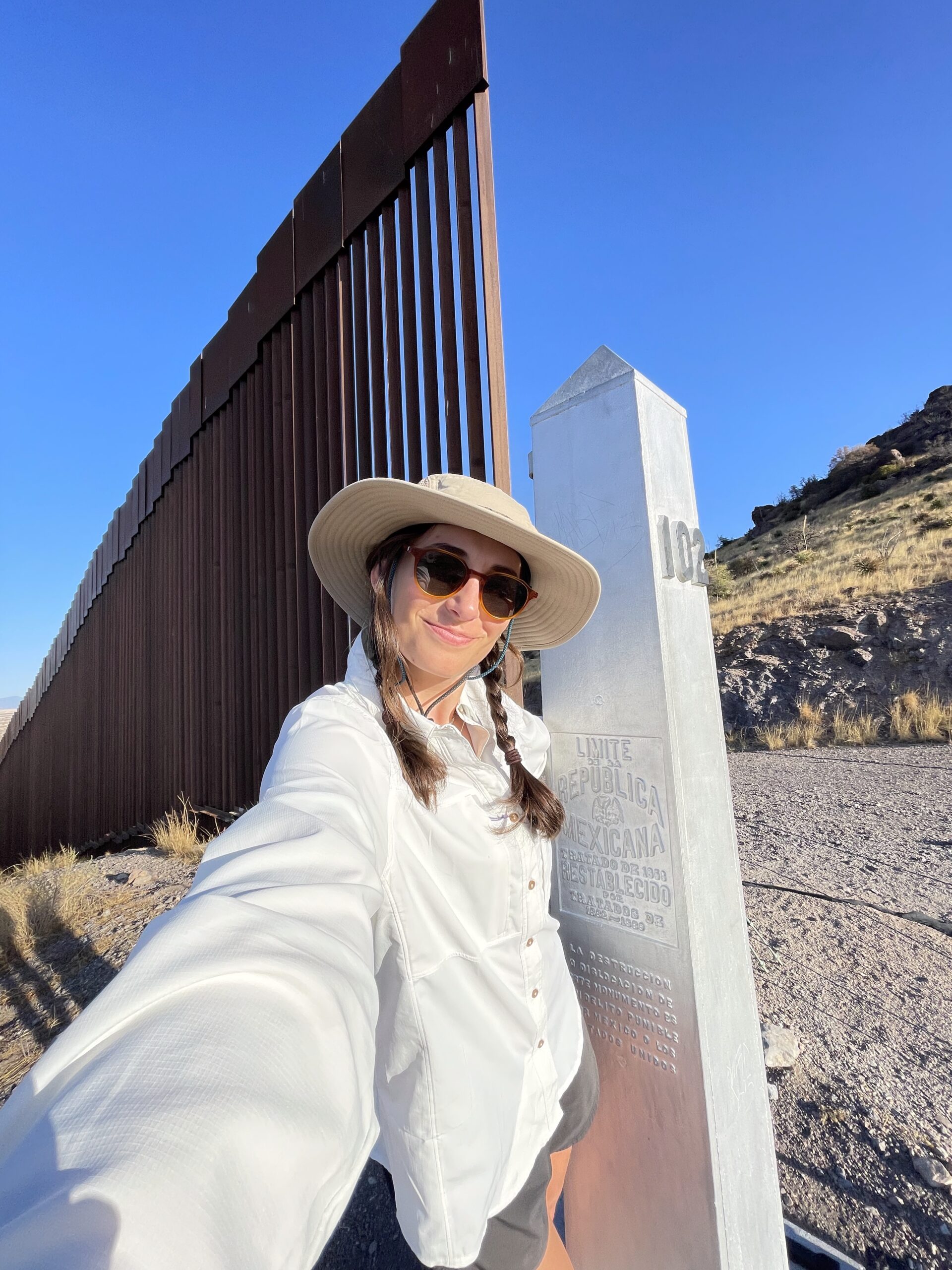 A woman at the southern terminus of the Arizona trail