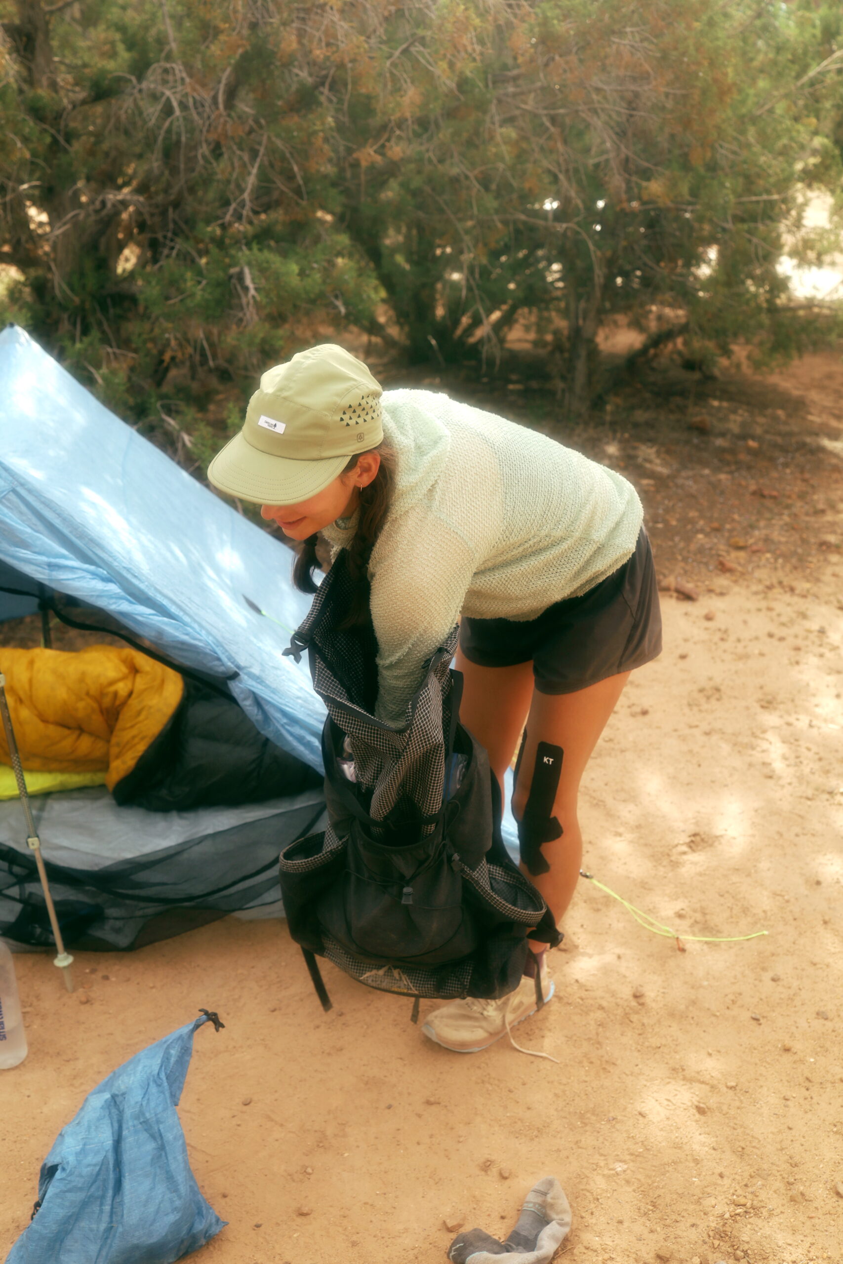 A woman packs her backpack on the Arizona Trail