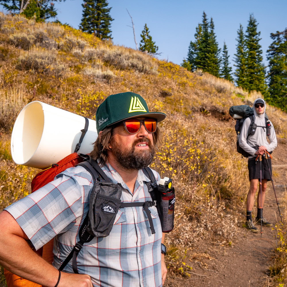 A backpacker wears a NewEra hat on the trail